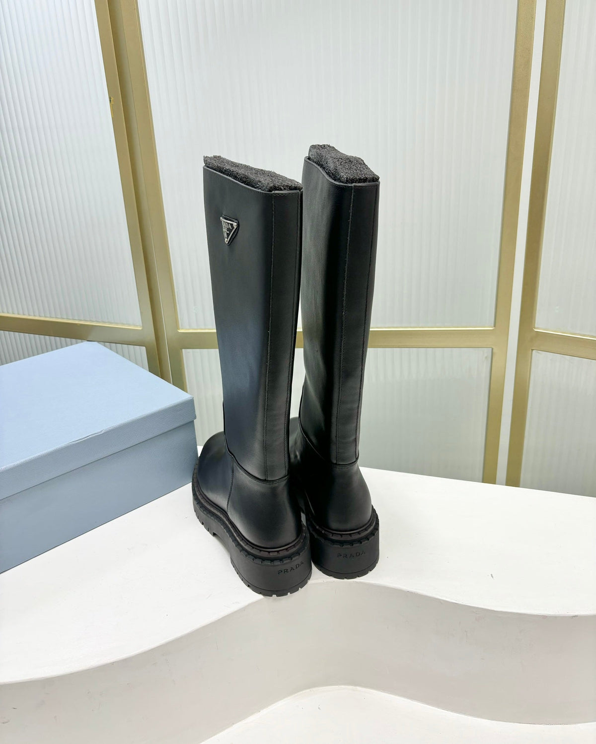 KNEE BOOTS WITH TRIANGLE LOGO IN BLACK CALFSKIN