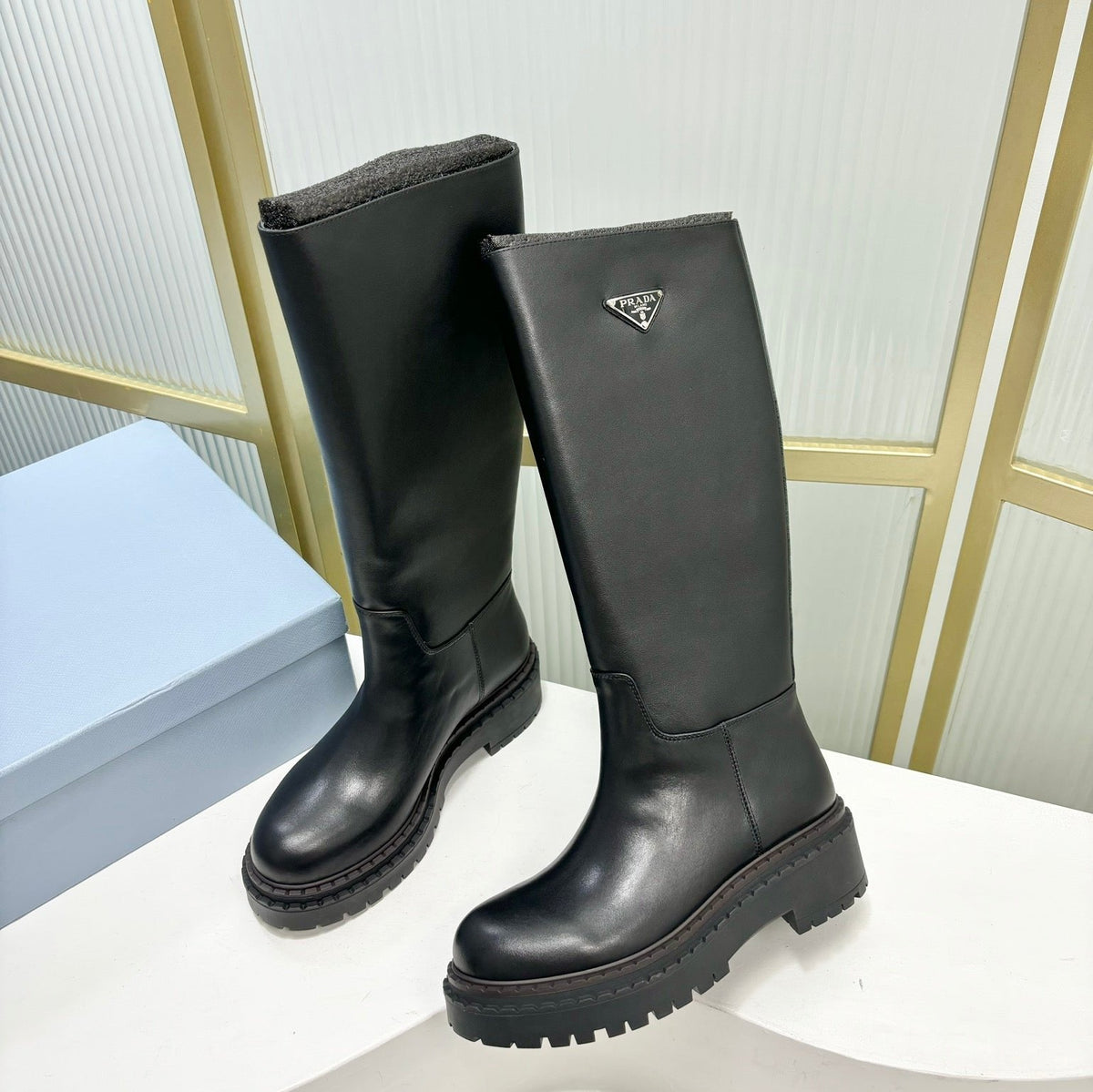 KNEE BOOTS WITH TRIANGLE LOGO IN BLACK CALFSKIN